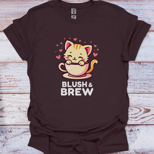 Brown t-shirt with a cat holding a coffee cup graphic and 'Blush & Brew' text on a wooden surface.