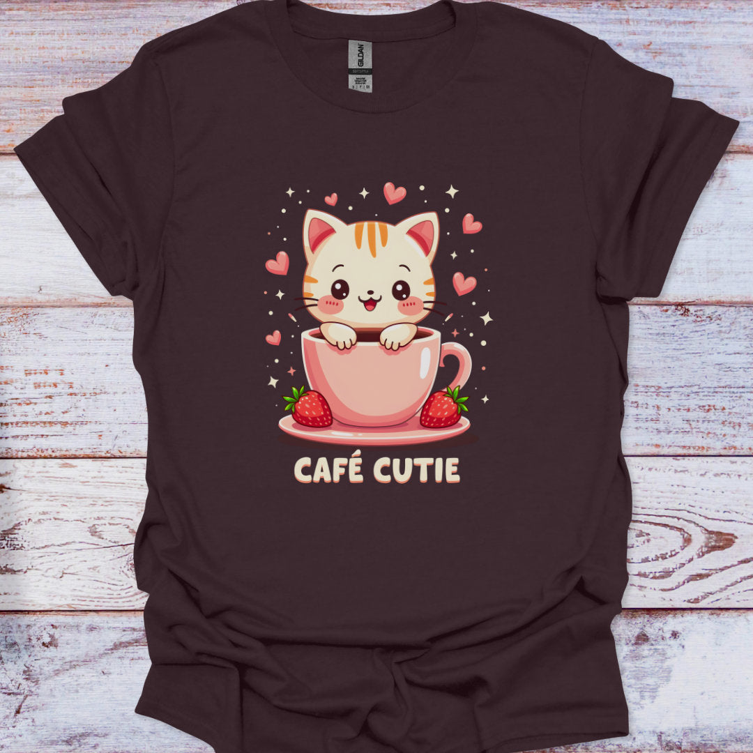 Brown t-shirt with a cat in a coffee cup graphic and 'Café Cutie' text on a wooden surface