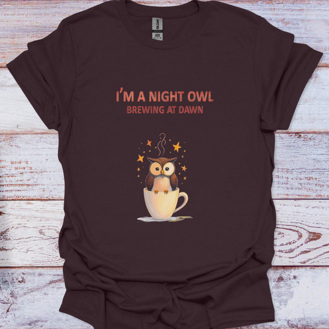 Brown t-shirt with an owl graphic and text on a wooden surface