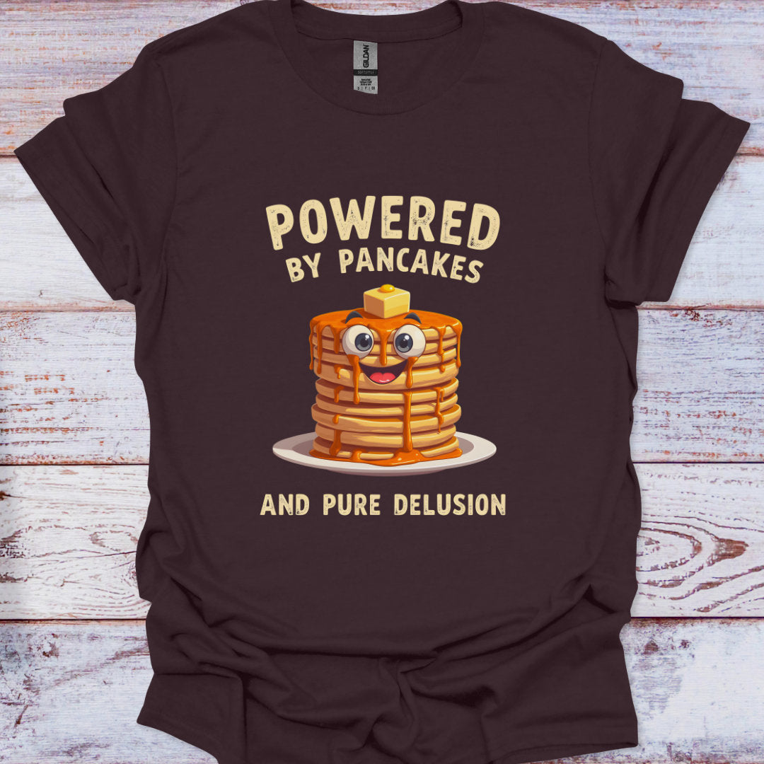 Brown t-shirt with a graphic of pancakes and text on a wooden surface