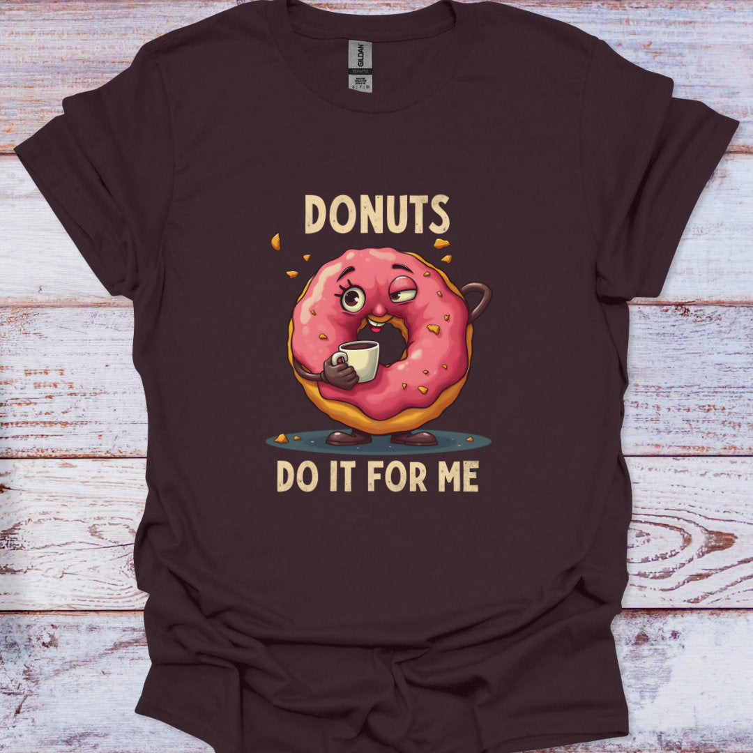 Brown t-shirt with a cartoon donut holding a coffee cup and text 'DONUTS DO IT FOR ME' on a wooden surface.
