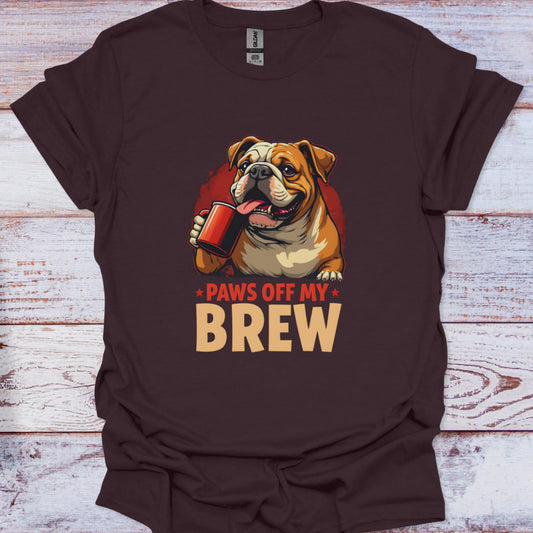 Brown t-shirt with a bulldog graphic and 'Paws Off My Brew' text on a wooden surface