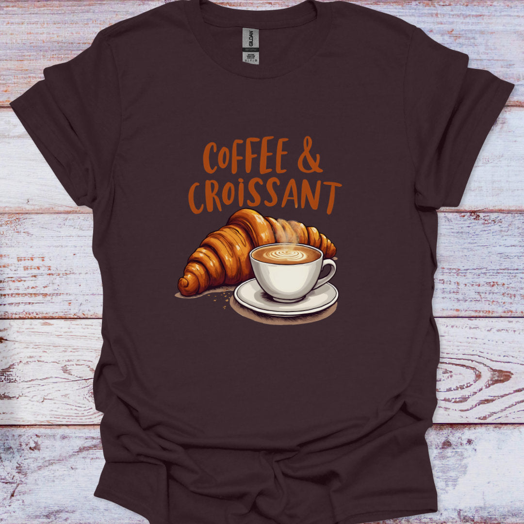 Brown t-shirt with 'Coffee & Croissant' graphic on a wooden surface
