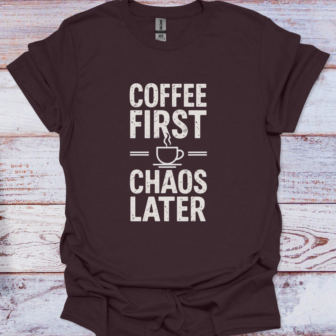 Brown t-shirt with 'Coffee First, Chaos Later' text on a wooden surface