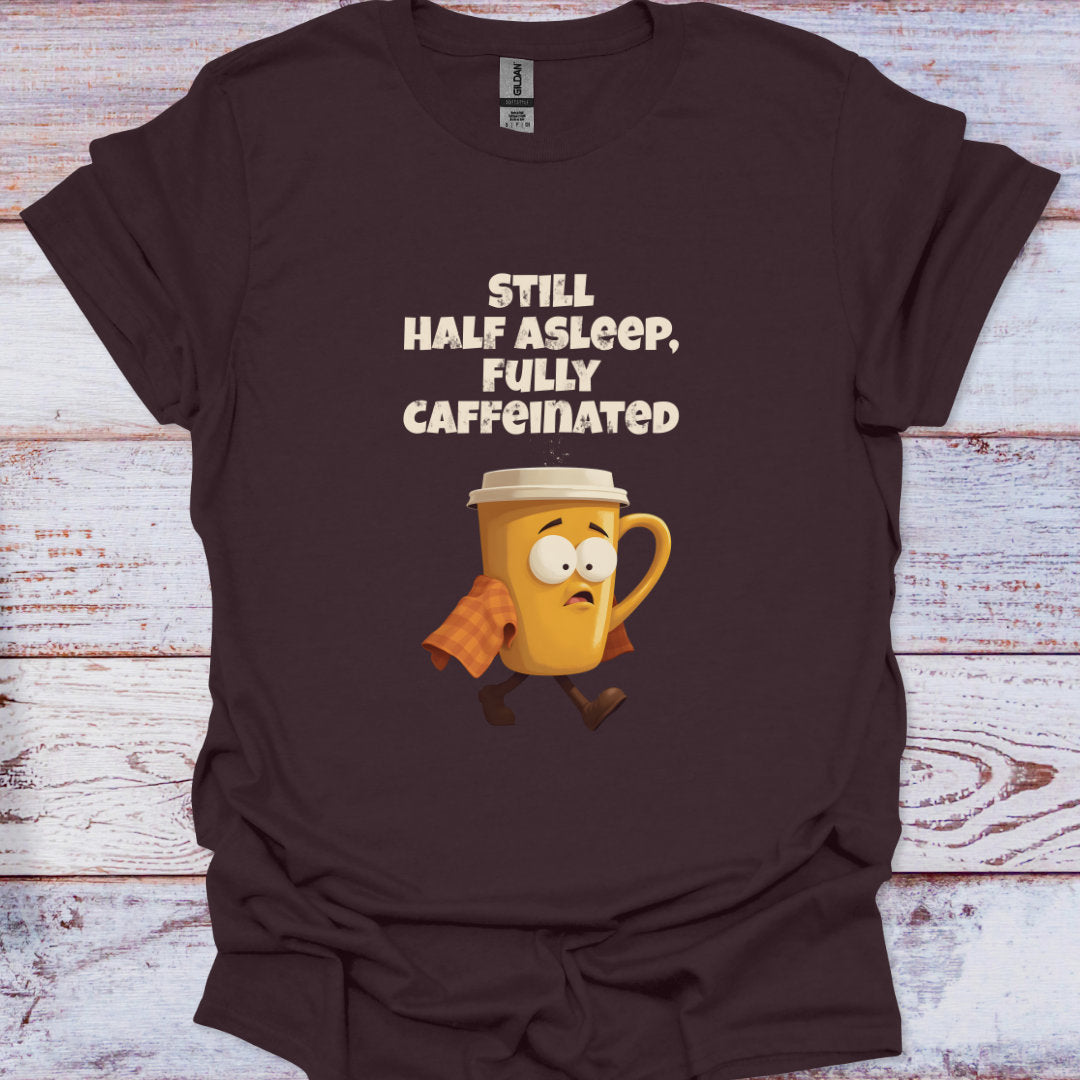 Brown t-shirt with a cartoon coffee mug and text on a wooden surface