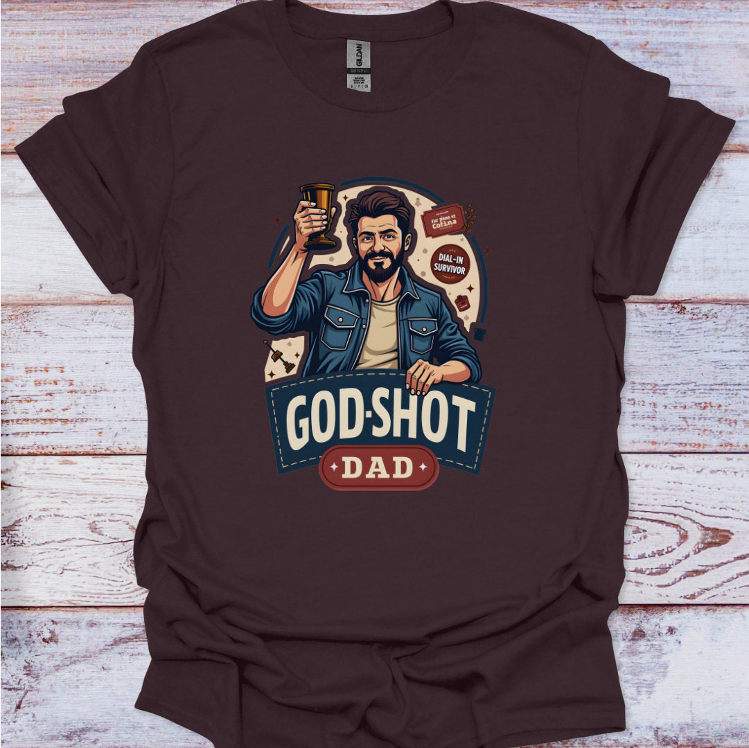 Brown t-shirt with a graphic of a man holding a beer mug and text 'God-Shot Dad' on a wooden surface.