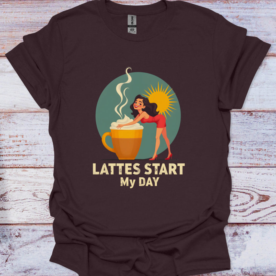 Brown t-shirt with a graphic of a woman by a coffee cup and text 'Lattes Start My Day' on a wooden surface.