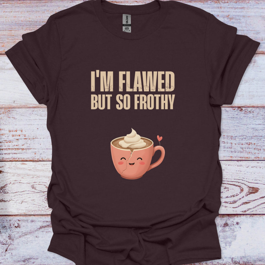 Brown t-shirt with a cartoon coffee cup and text 'I'm Flawed But So Frothy' on a wooden surface