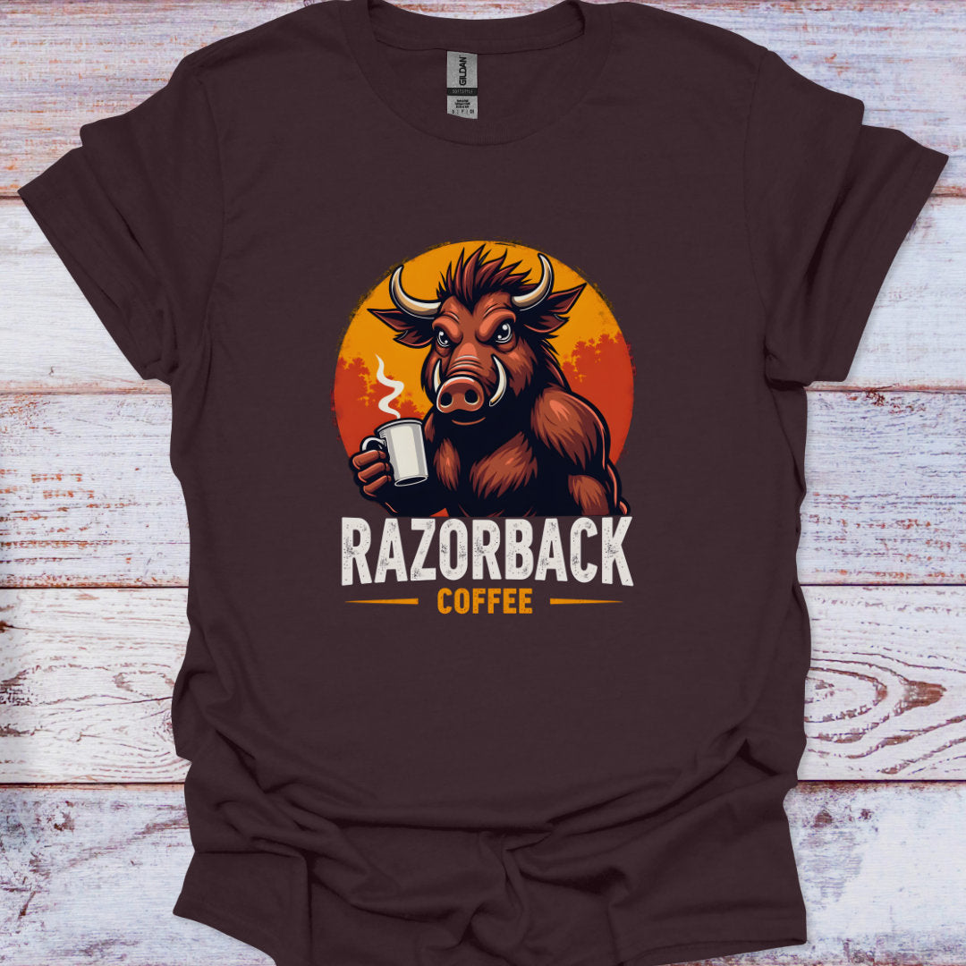 Brown t-shirt with a Razorback coffee graphic on a wooden surface
