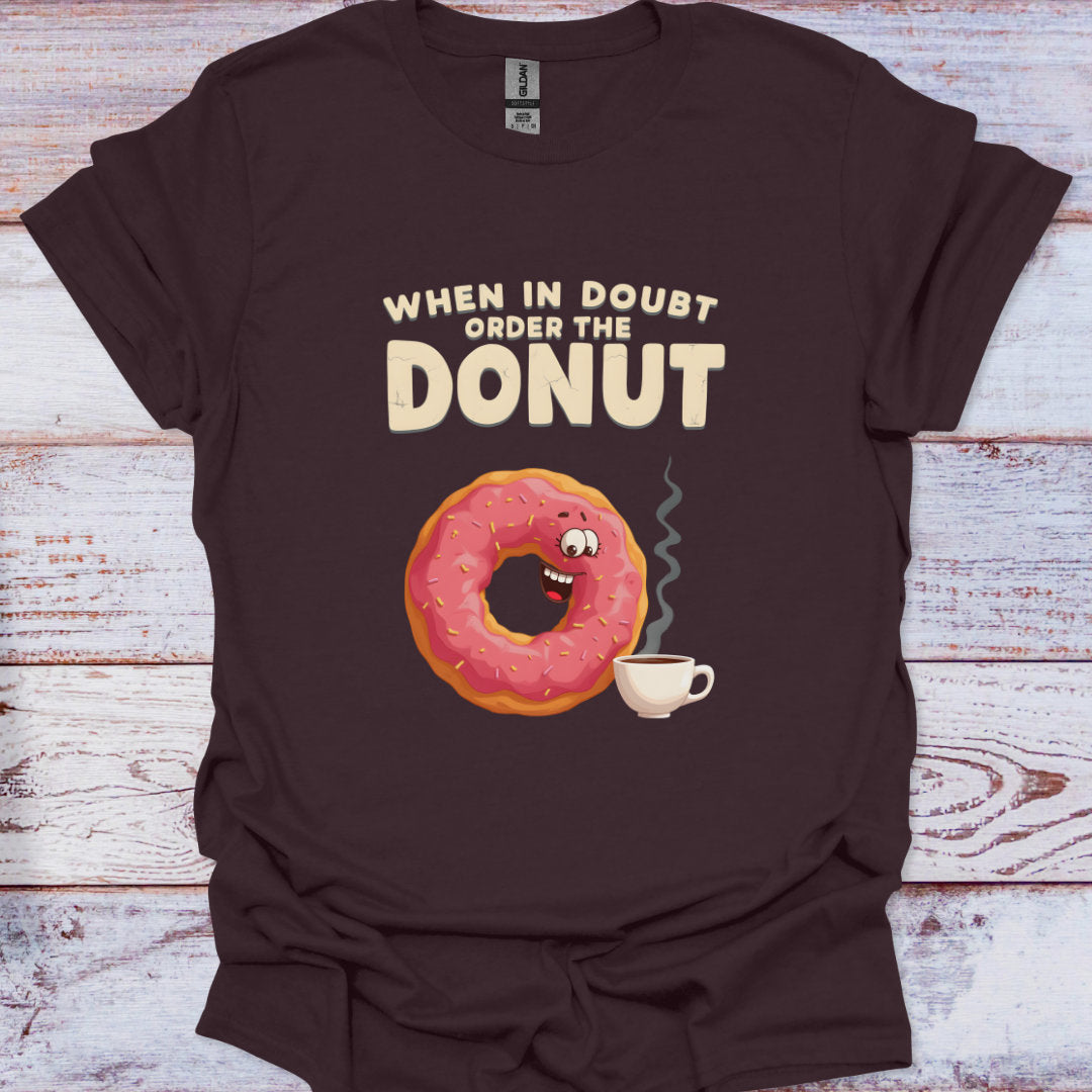 Brown t-shirt with a donut graphic and text on a wooden surface