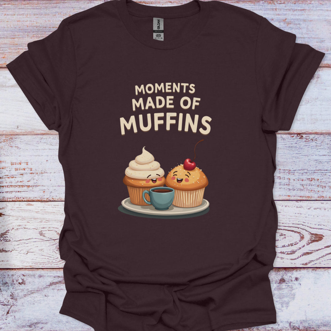 Brown t-shirt with cartoon muffins and 'Moments Made of Muffins' text on a wooden surface