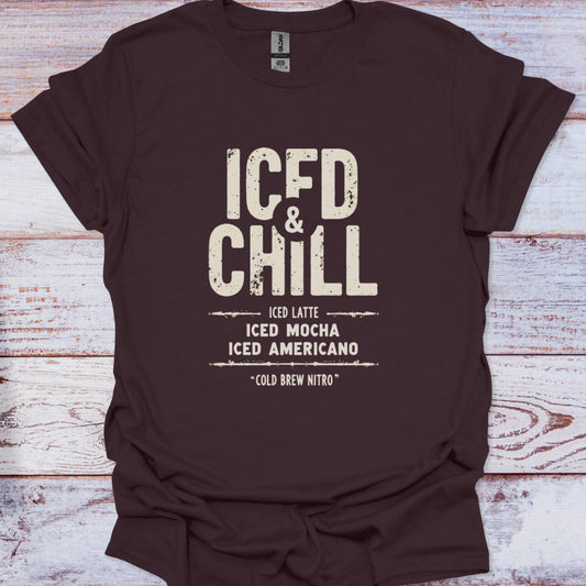 Brown t-shirt with 'ICED & CHILL' text on a wooden surface