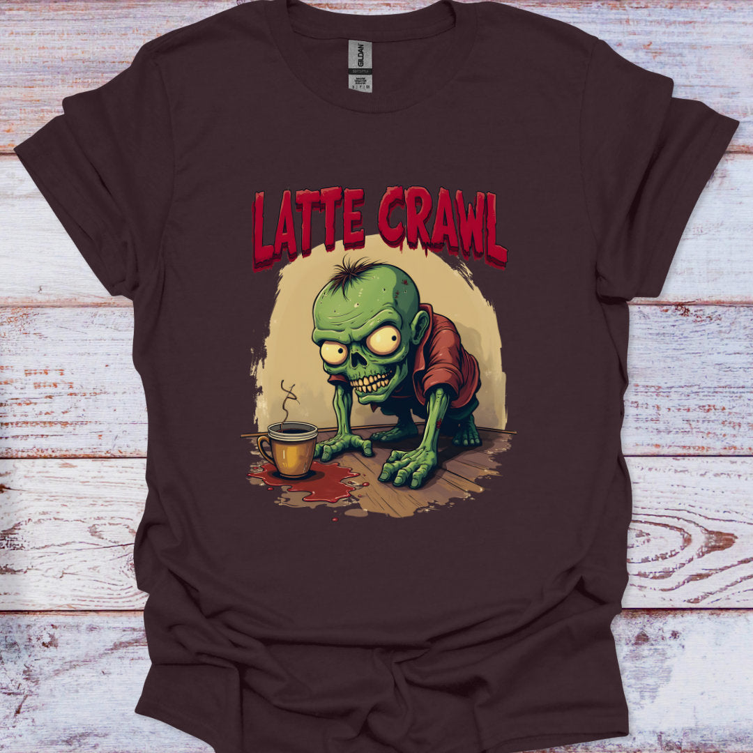 Brown t-shirt with a graphic of a green creature and 'Latte Crawl' text on a wooden surface.