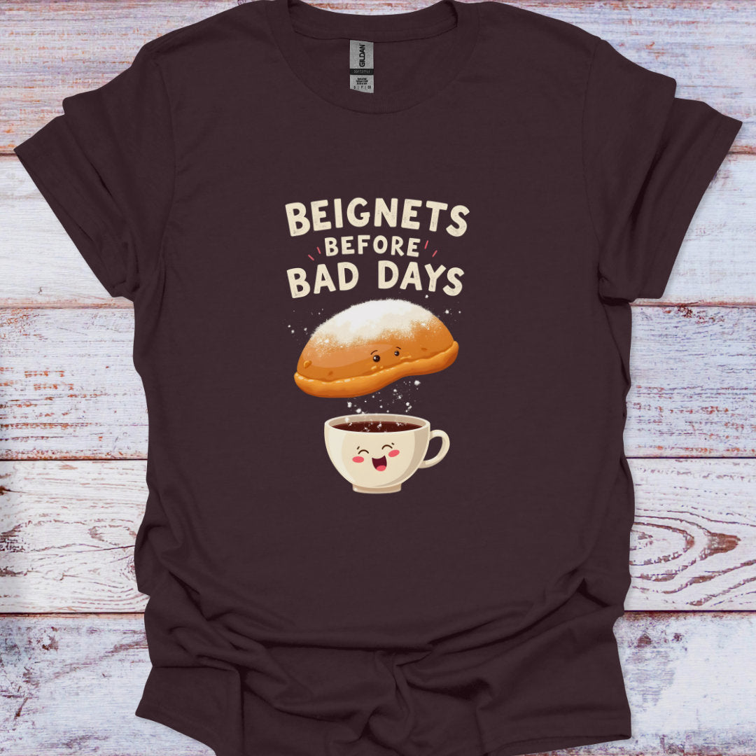 Brown t-shirt with a graphic of a beignet and coffee cup on a wooden surface
