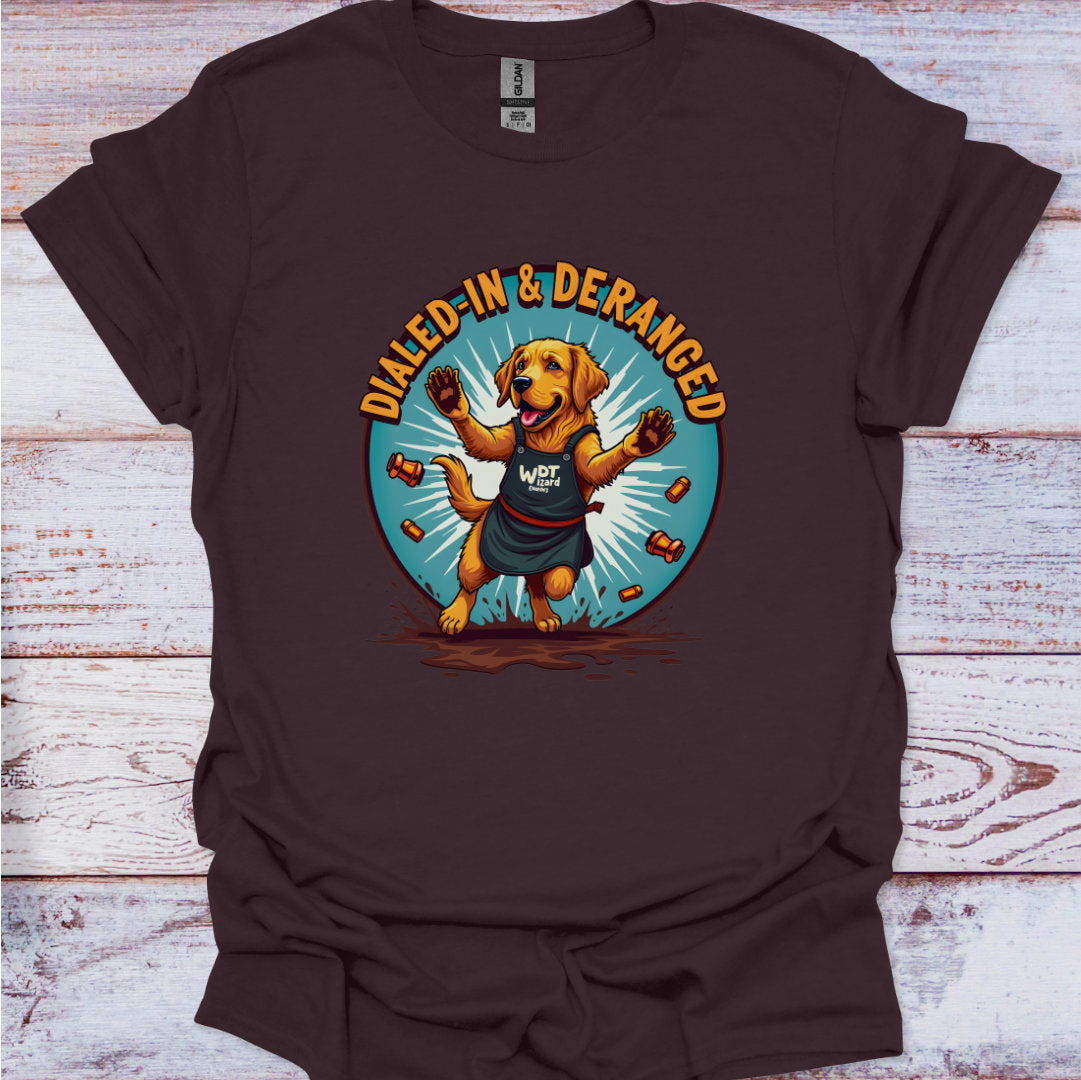 Brown t-shirt with a dog graphic and 'Dialed-In & Deranged' text on a wooden surface