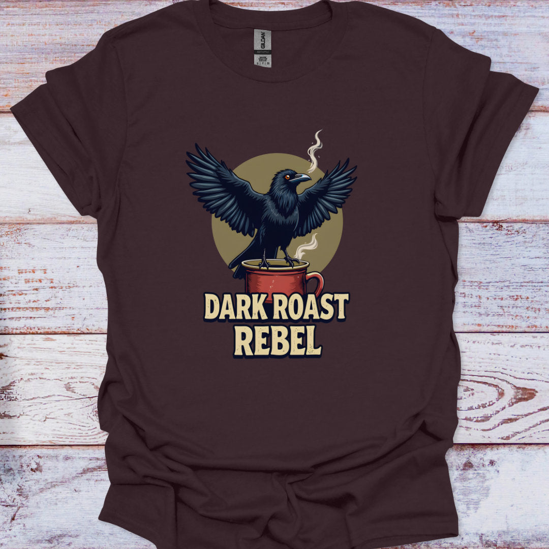 Brown t-shirt with a crow and coffee cup graphic and 'Dark Roast Rebel' text on a wooden surface.