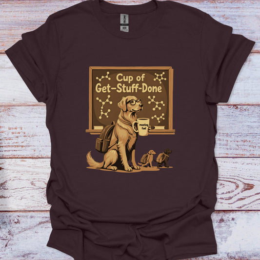 Brown t-shirt with a graphic of a dog holding a mug and a chalkboard on a wooden surface