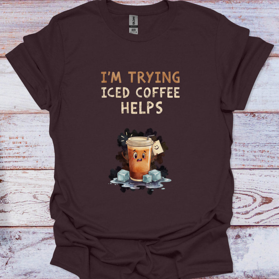 Brown t-shirt with 'I'm Trying Iced Coffee Helps' graphic on a wooden surface