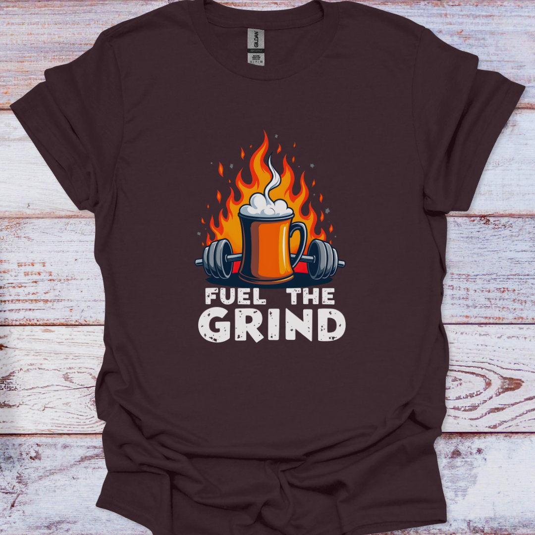 Brown t-shirt with 'Fuel the Grind' graphic design featuring a mug with flames and weights on a wooden background.