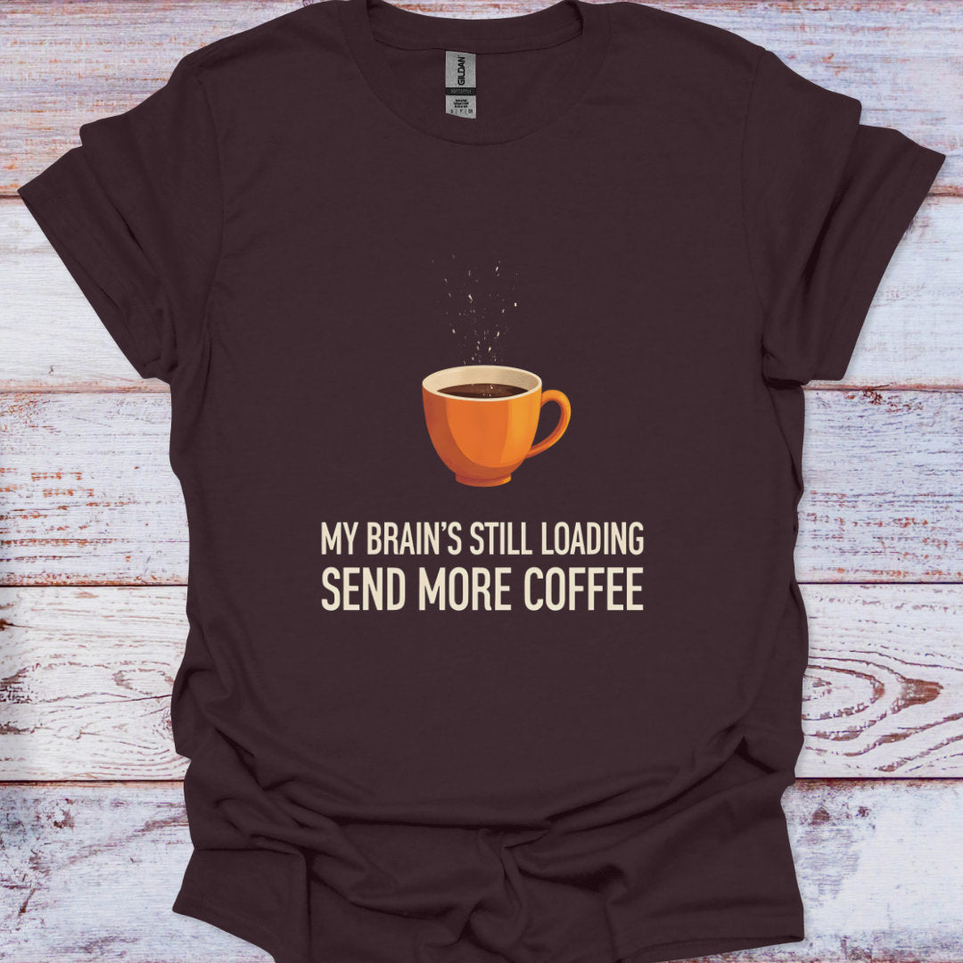 Brown t-shirt with a coffee cup graphic and text on a wooden surface