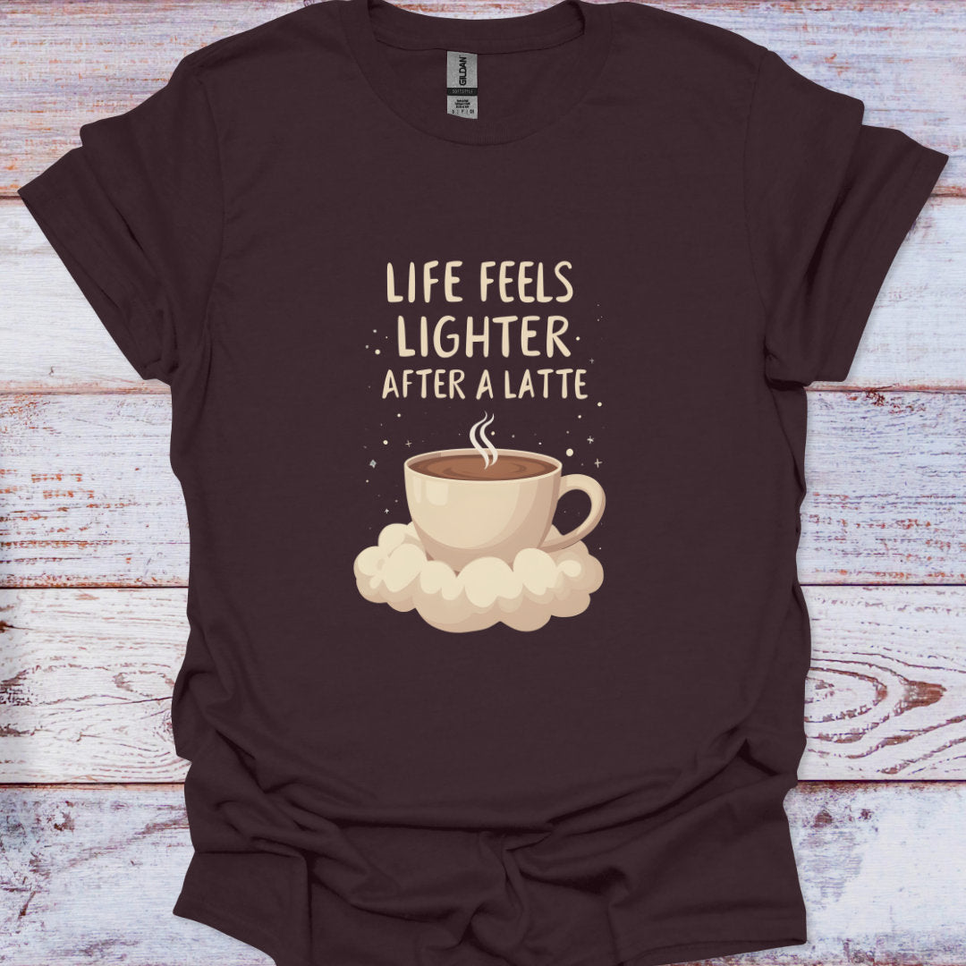Brown t-shirt with a coffee cup graphic and text on a wooden surface