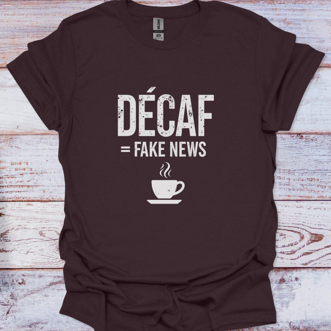 Brown t-shirt with 'Décaf = Fake News' text and coffee cup graphic on a wooden surface