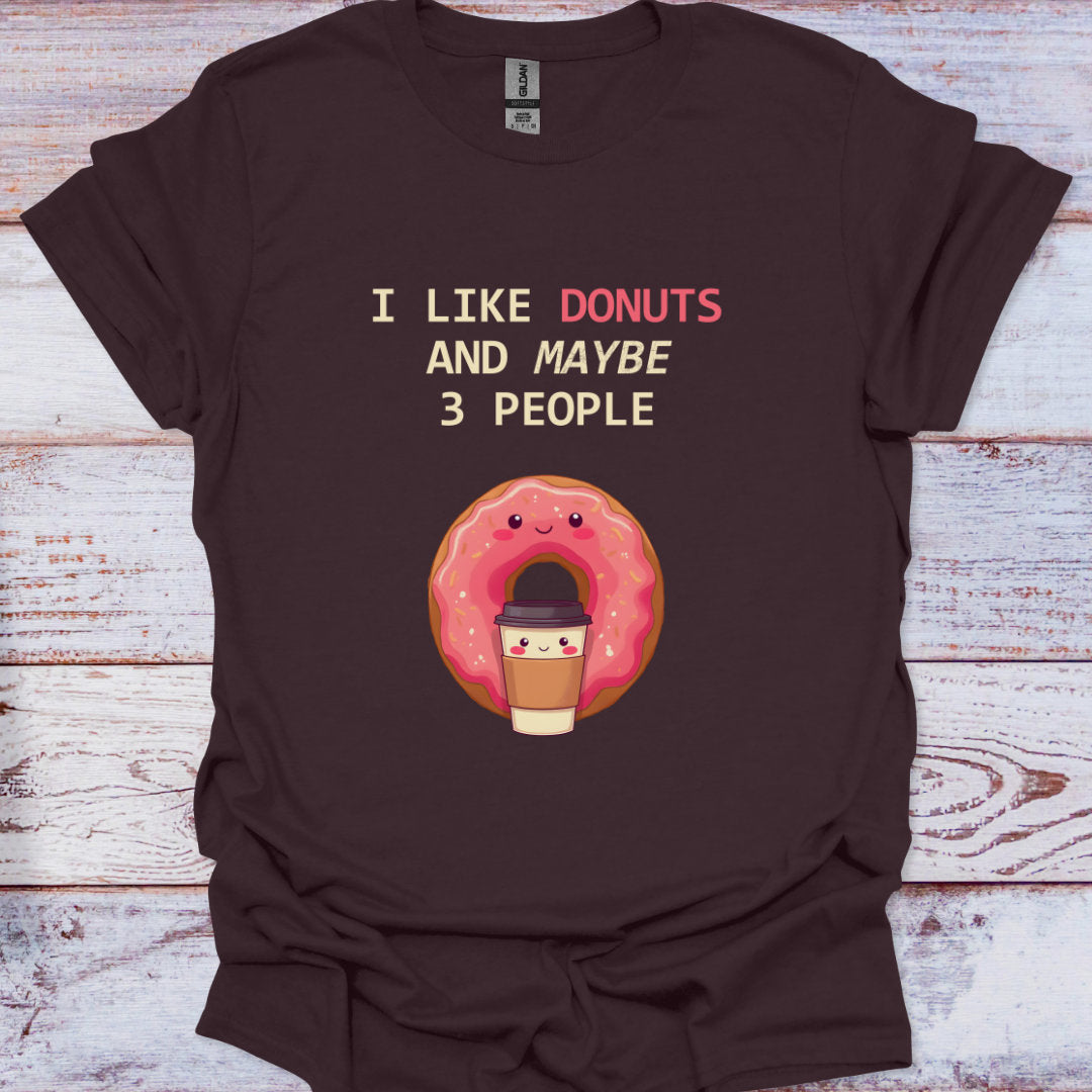 Brown t-shirt with a donut graphic and text on a wooden surface