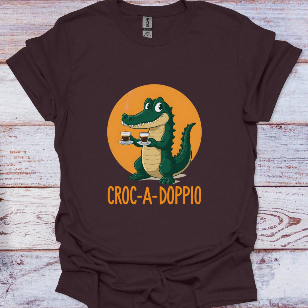 Brown t-shirt with a cartoon crocodile holding coffee cups and 'Croc-A-Doppio' text on an orange circle background.