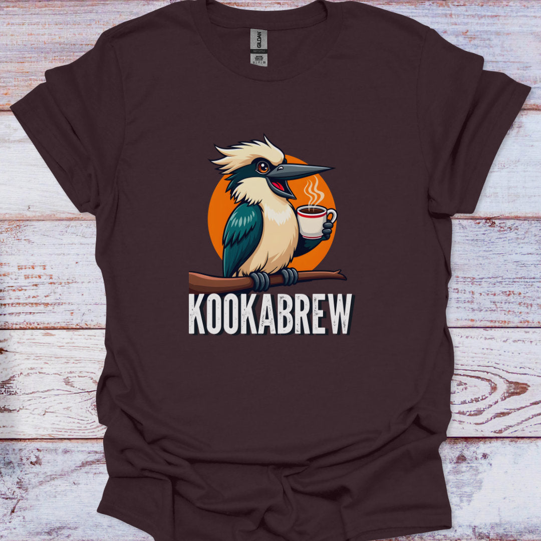 Brown t-shirt with a kookaburra holding a coffee cup graphic and 'KOOKABREW' text on a wooden surface.