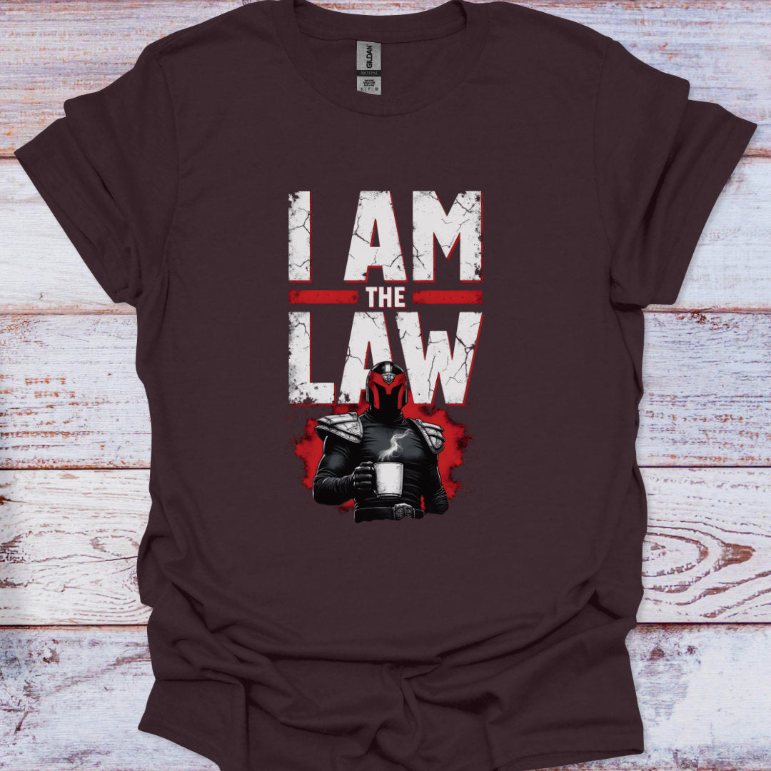 Brown t-shirt with 'I AM THE LAW' graphic on a wooden surface
