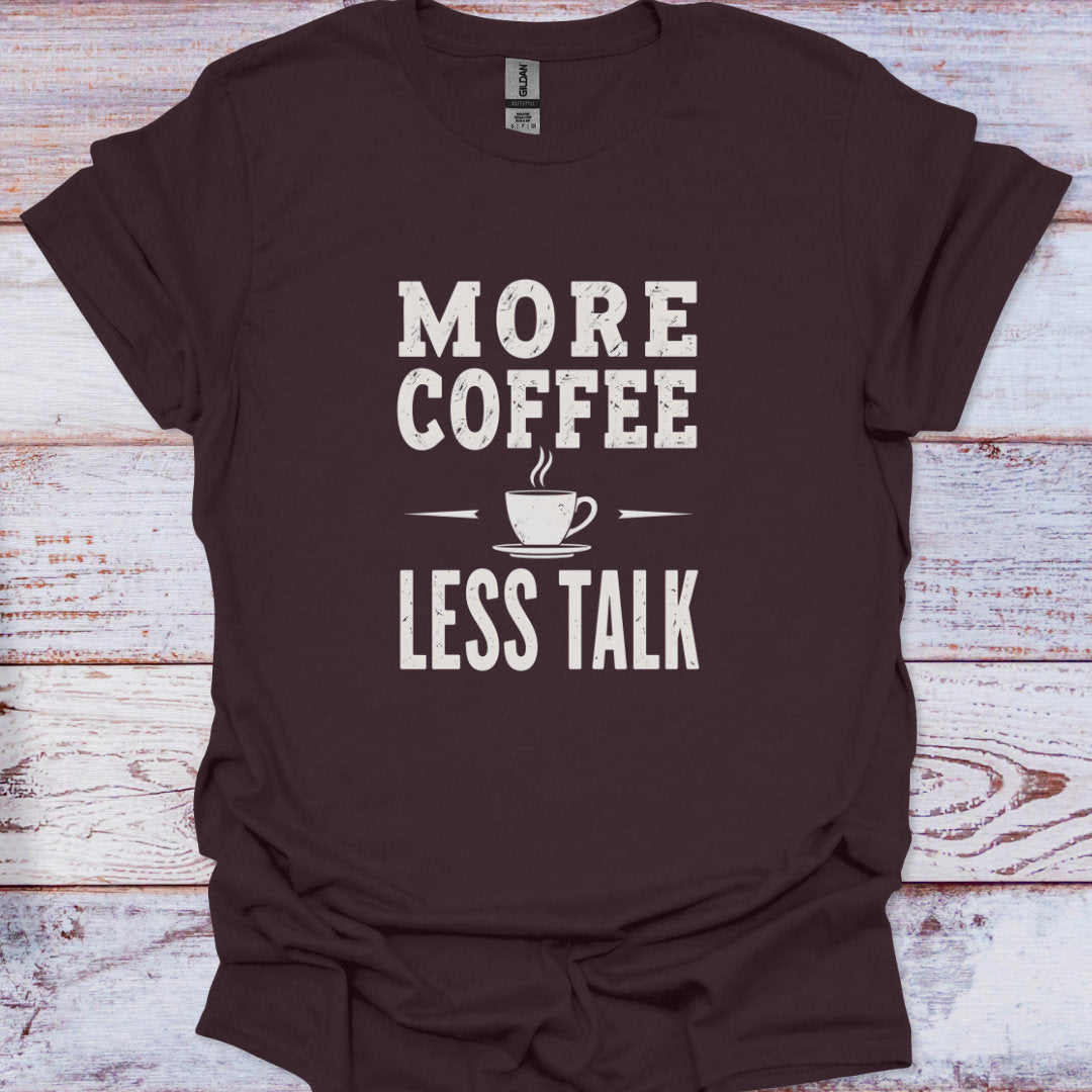Brown t-shirt with 'More Coffee Less Talk' text on a wooden surface