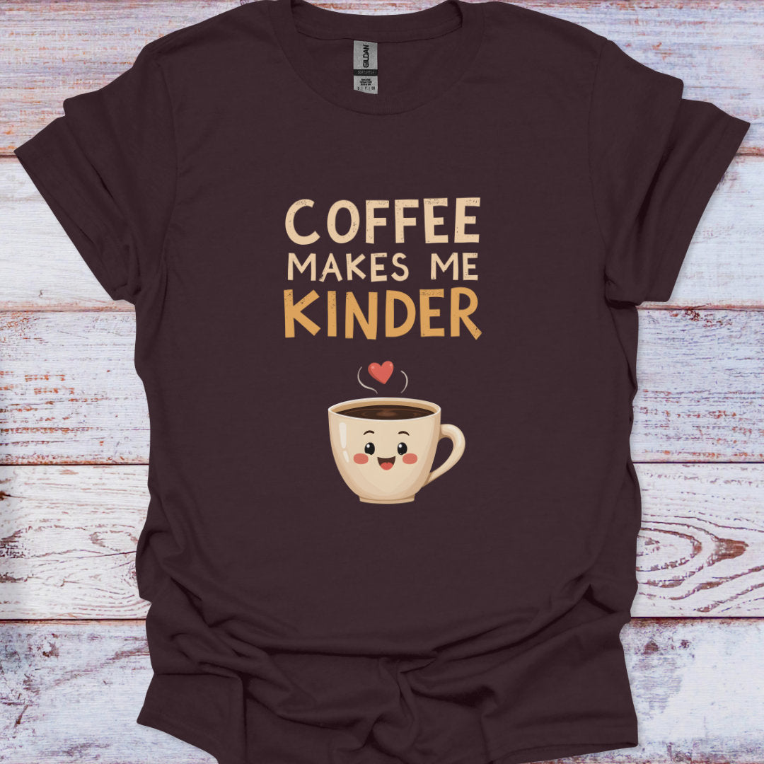 Brown t-shirt with a cartoon coffee cup and text 'Coffee Makes Me Kinder' on a wooden surface.