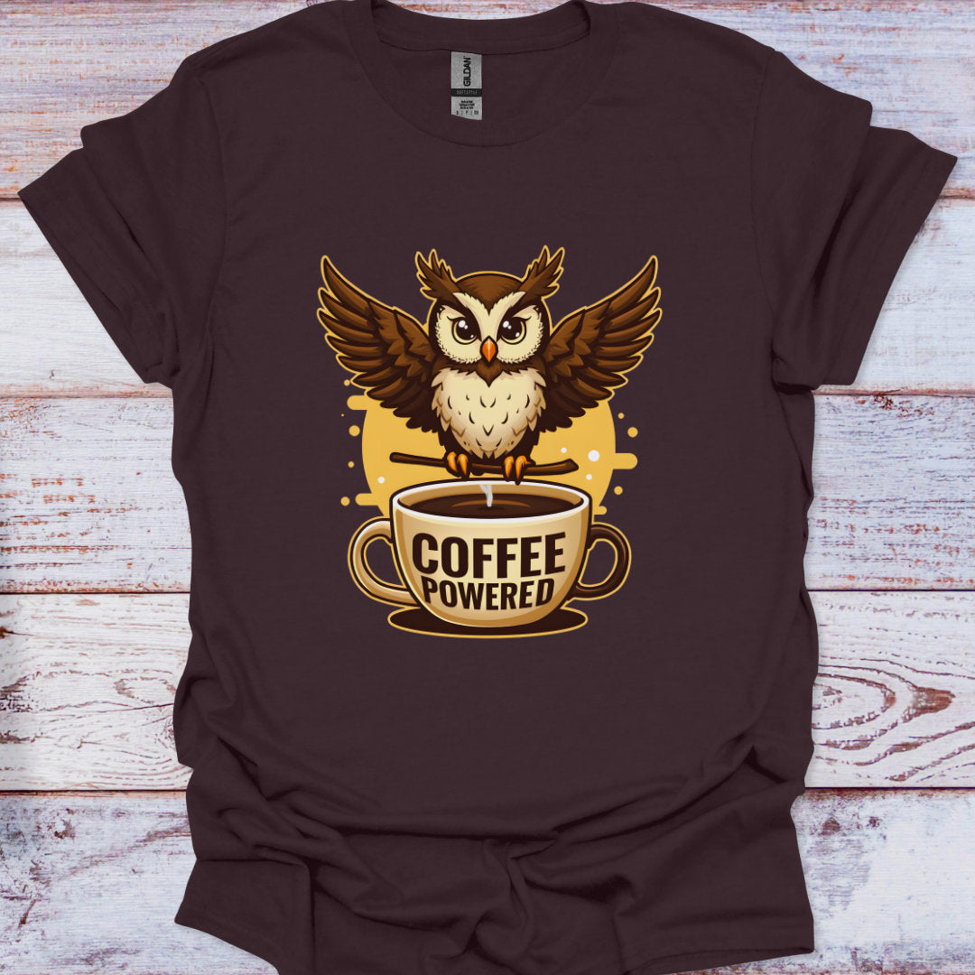 Brown t-shirt with an owl and coffee cup graphic on a wooden surface