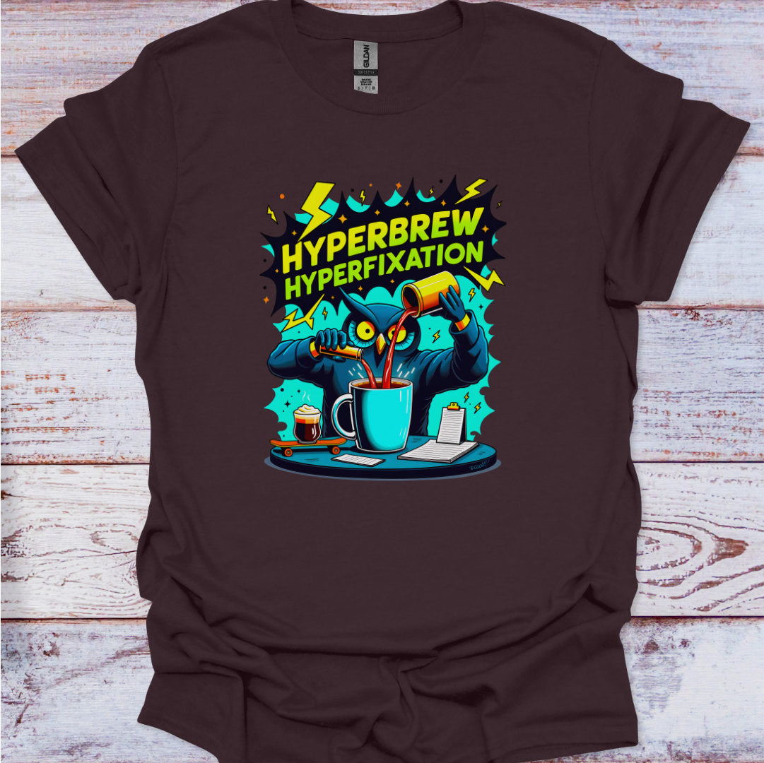 Brown t-shirt with 'Hyperbrew Hyperfixation' graphic design on a wooden surface