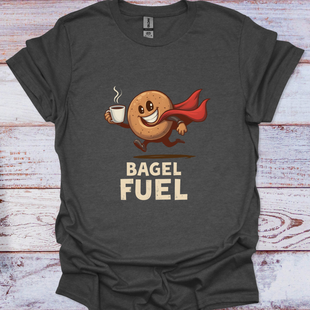 Dark gray t-shirt with a cartoon bagel character holding a coffee cup and text 'Bagel Fuel' on a wooden surface.