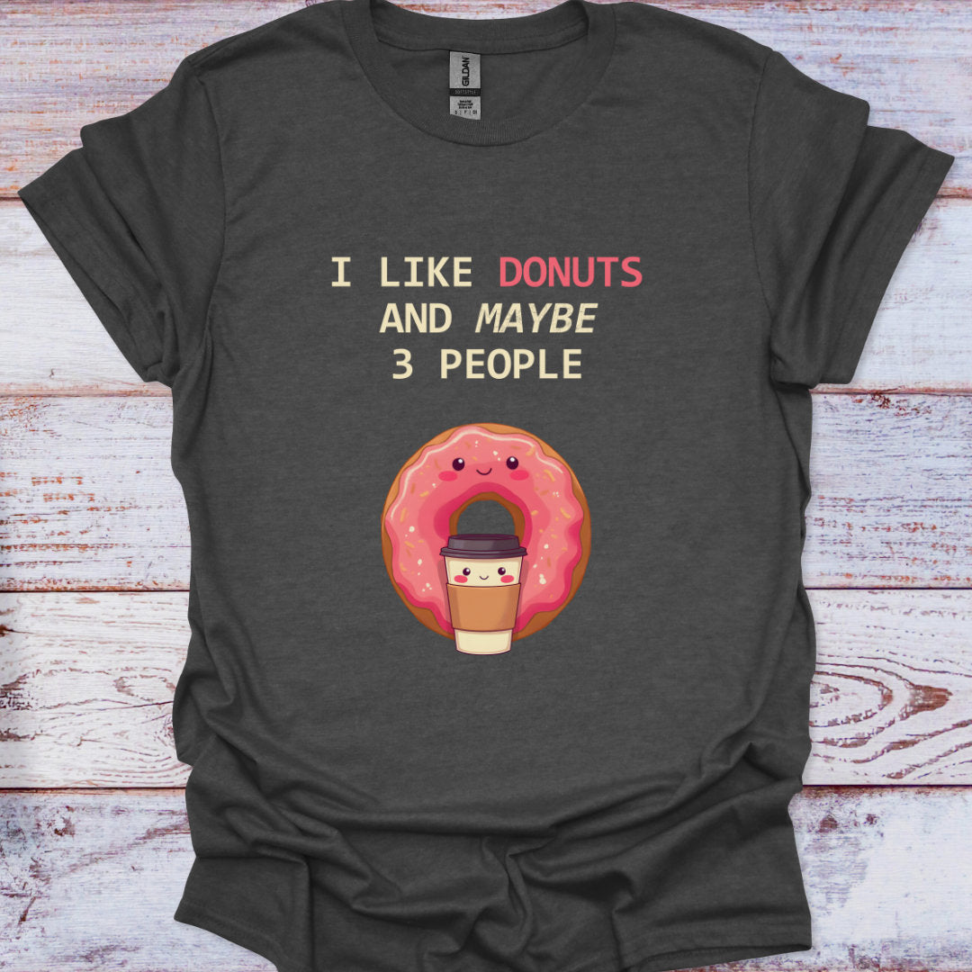 Dark gray t-shirt with a cartoon donut and text on a wooden surface