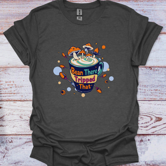 Dark gray t-shirt with a colorful coffee cup graphic and text on a wooden surface
