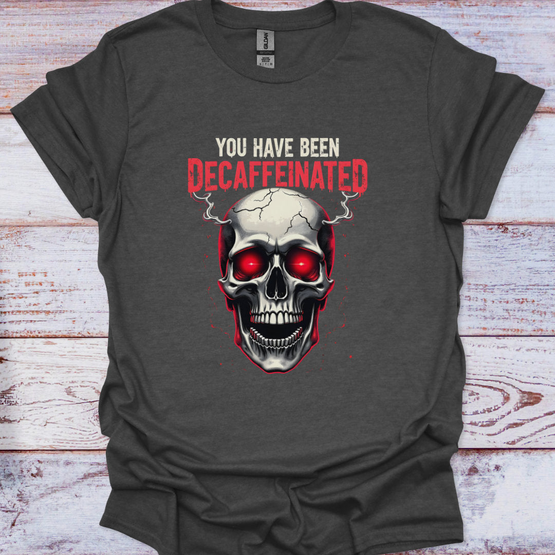 Gray t-shirt with a skull graphic and text 'You have been decaffeinated' on a wooden surface