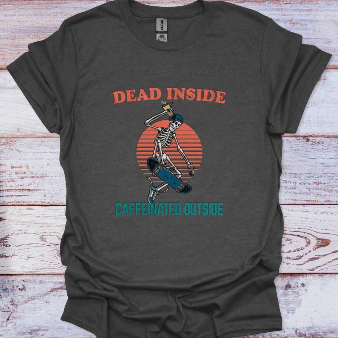 Gray t-shirt with skeleton design and text 'Dead Inside, Caffeinated Outside' on a wooden surface