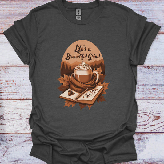 Dark gray t-shirt with a coffee-themed graphic and 'Life's a Brew-tiful Grind' text on a wooden surface.