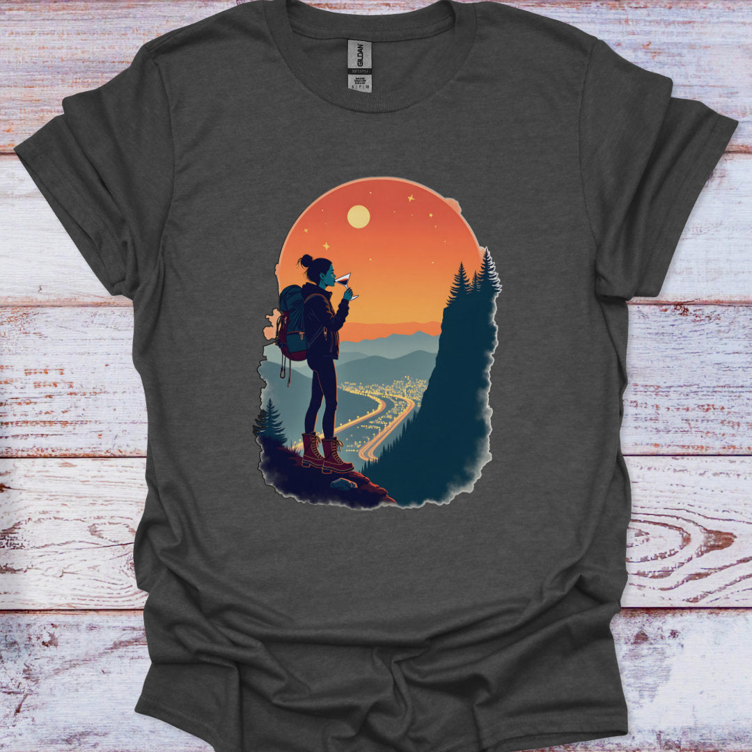 Dark gray t-shirt with a graphic of a hiker and sunset design on a wooden surface