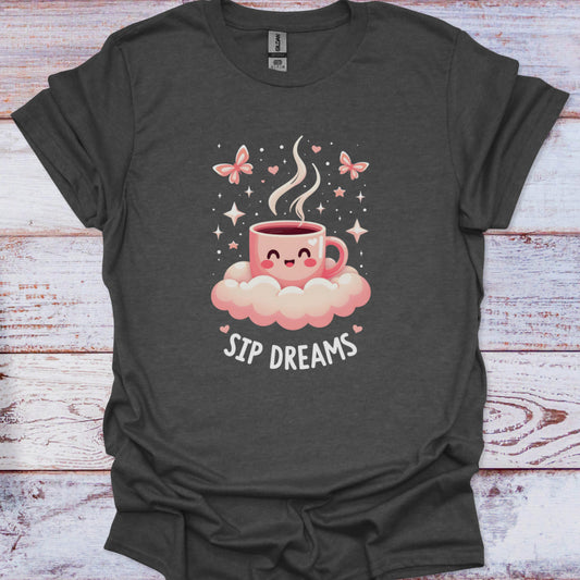 Dark gray t-shirt with a cartoon coffee cup on a cloud and 'Sip Dreams' text, on a wooden surface.