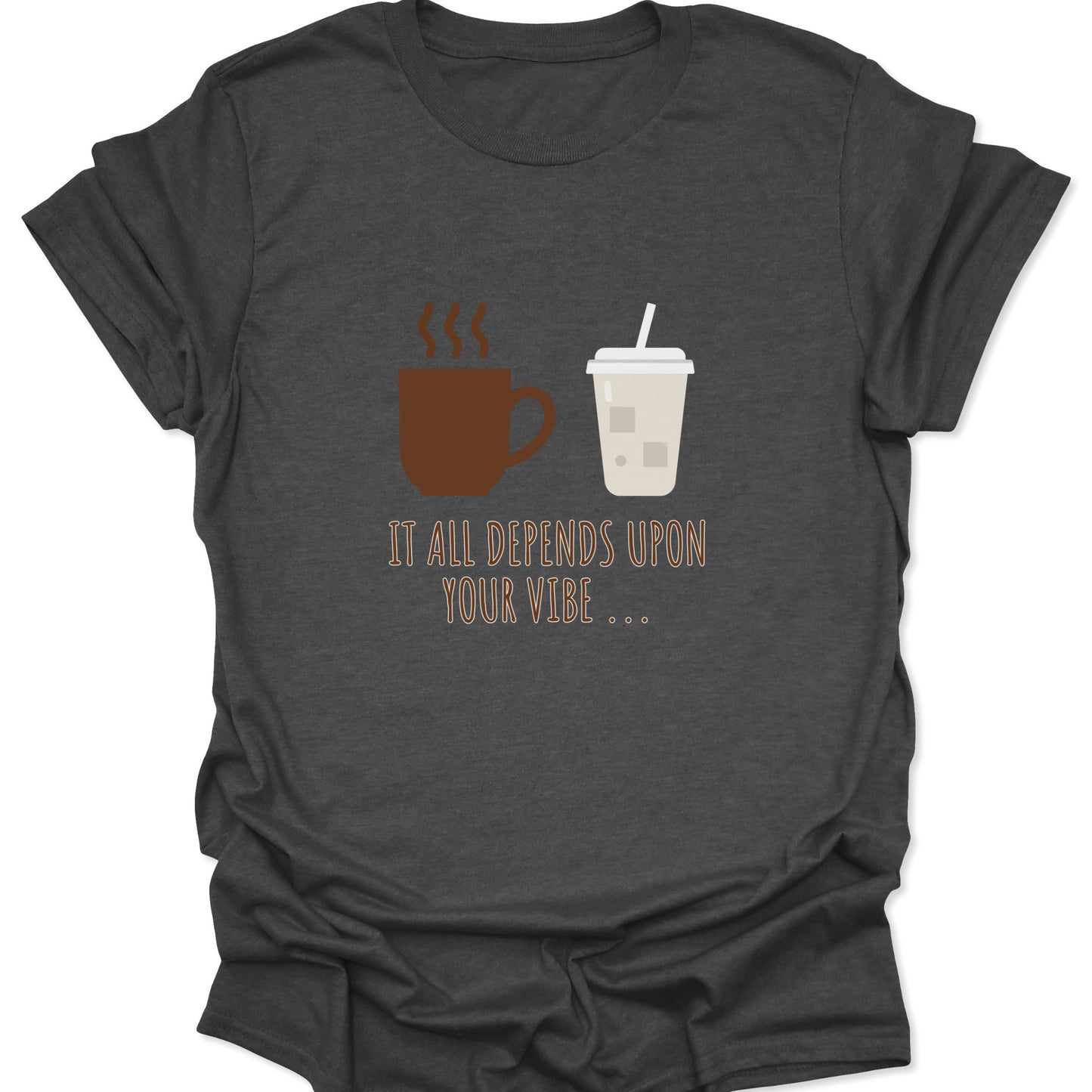 Graphic tee on dark heather gray fabric featuring a brown steaming coffee mug and a light beige iced coffee cup with the text "IT ALL DEPENDS UPON YOUR VIBE..." in thin brown lettering.