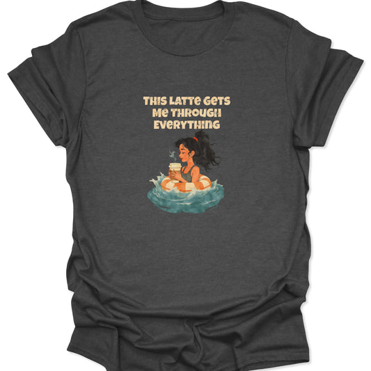 Dark heather gray t-shirt with a cross-niche, existential coffee survival design. Shows a woman in a lifesaver floating, with the text hook: "THIS LATTE GETS ME THROUGH EVERYTHING."