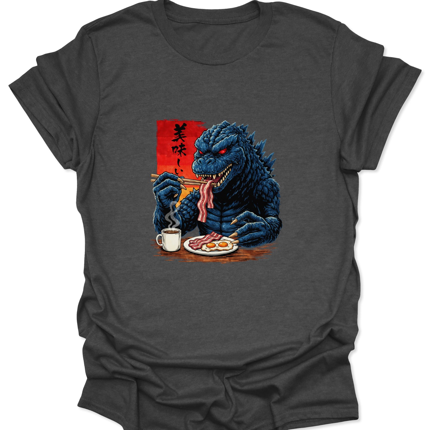 Graphic tee on a heather gray fabric featuring a blue scaly monster eating breakfast with chopsticks and a mug of coffee.