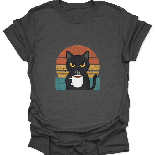 A dark heather gray t-shirt featuring a grumpy black cat holding a steaming white coffee mug centered in front of an orange and teal retro sunset.
