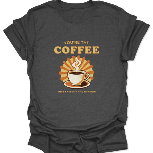 Dark heather gray graphic t-shirt showing a halftone coffee cup design and retro sunburst rays with caffeine-positive text.