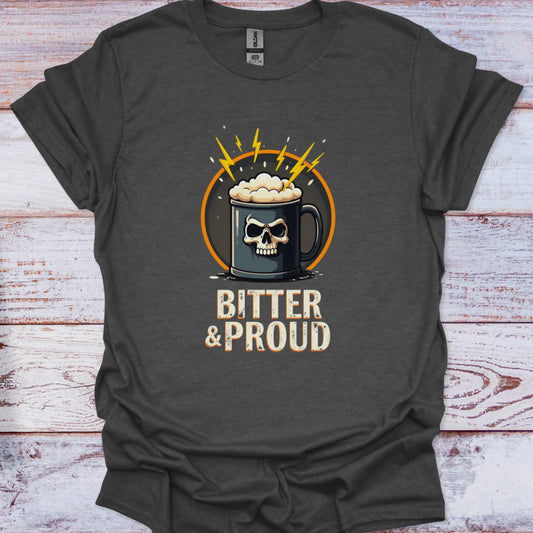 Dark gray t-shirt with a graphic of a skull in a mug with foam and text 'Bitter & Proud' on a wooden surface.