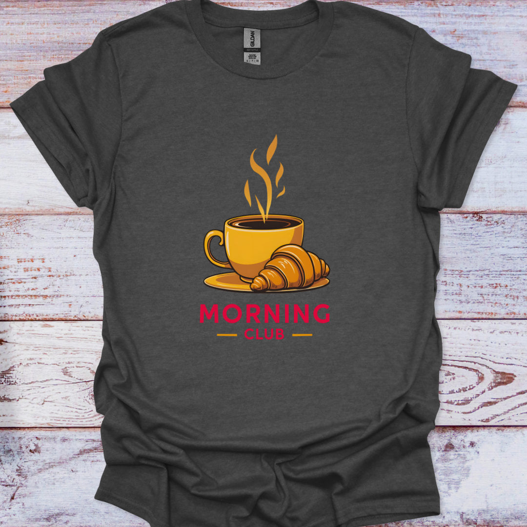 Dark gray t-shirt with a coffee cup and croissant graphic and 'Morning Club' text on a wooden surface.