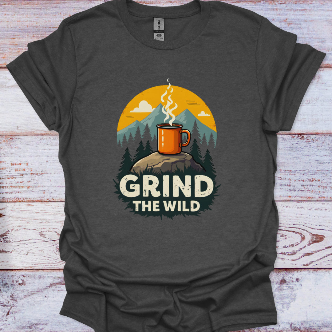 Dark gray t-shirt with a graphic of a mug and mountains, and the text 'Grind the Wild' on a wooden surface.